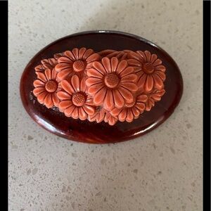 Vintage beautiful flower Celluloid salmon colored brooch on a wood plaque.